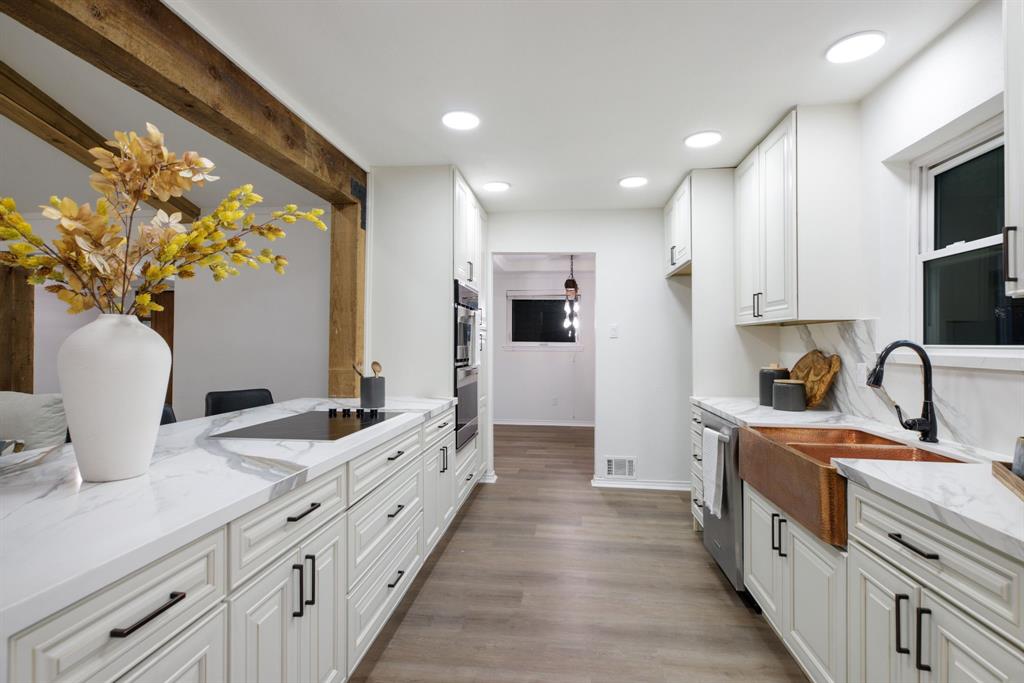 10922 Ferndale Road Dallas, TX 75238 - Photo 11 of 32 Kitchen featuring white cabinetry, light stone countertops, recessed lighting, light wood finished floors, and dishwasher