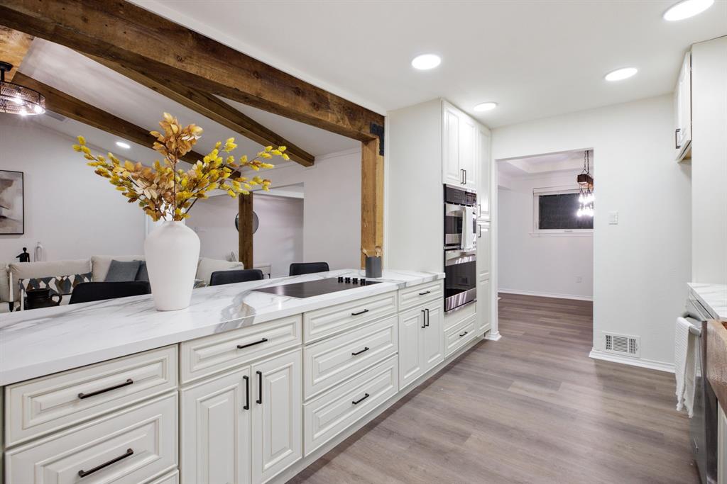 10922 Ferndale Road Dallas, TX 75238 - Photo 12 of 32 Kitchen with recessed lighting, white cabinetry, light wood-style flooring, light stone countertops, and decorative light fixtures