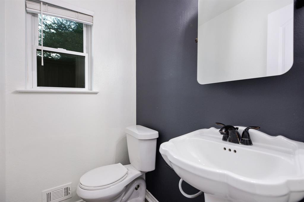 10922 Ferndale Road Dallas, TX 75238 - Photo 14 of 32 Half bathroom featuring toilet and a sink