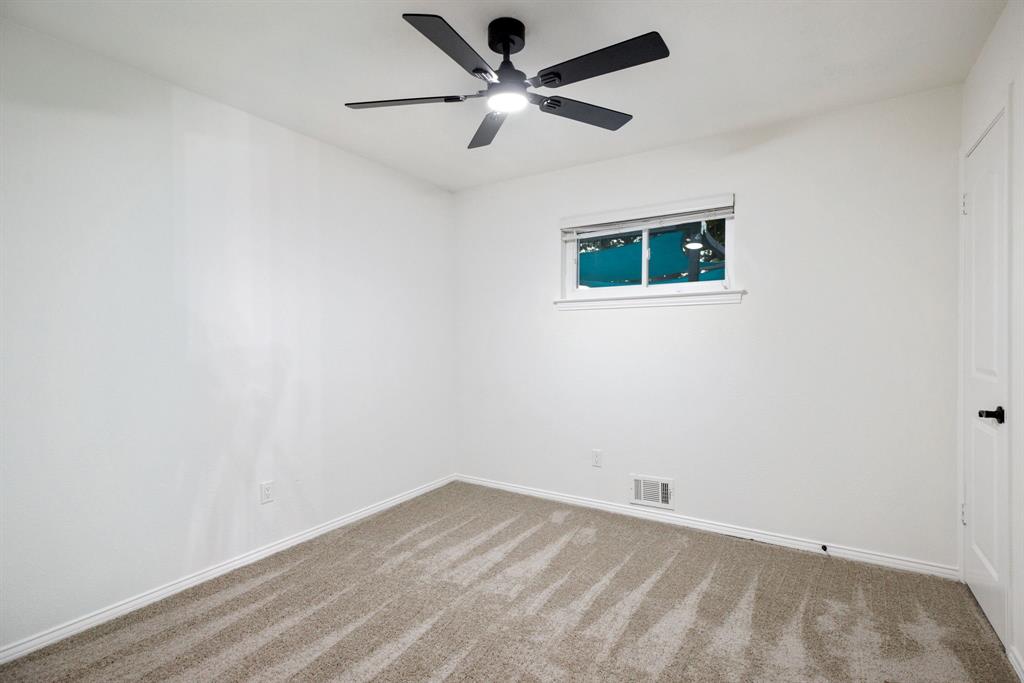 10922 Ferndale Road Dallas, TX 75238 - Photo 16 of 32 Carpeted empty room with baseboards and ceiling fan