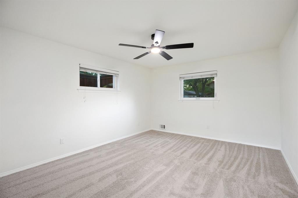 10922 Ferndale Road Dallas, TX 75238 - Photo 18 of 32 Empty room featuring carpet and ceiling fan