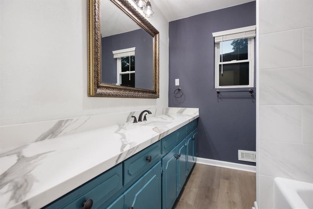10922 Ferndale Road Dallas, TX 75238 - Photo 19 of 32 Bathroom with vanity, dark wood-style flooring, and a bath