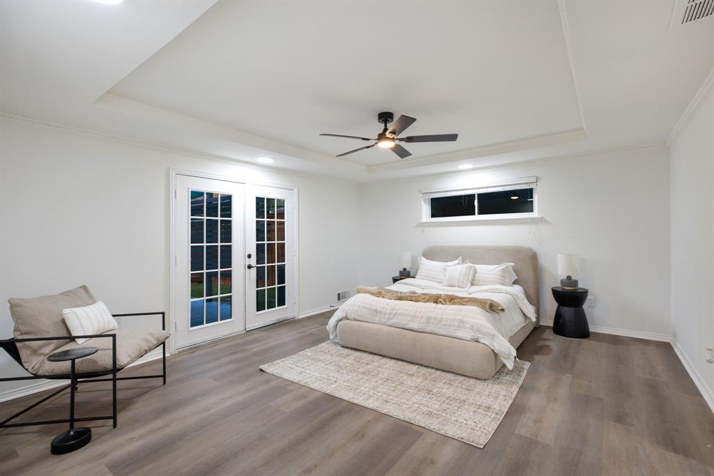 10922 Ferndale Road Dallas, TX 75238 - Photo 20 of 32 Bedroom with a raised ceiling, access to outside, french doors, ornamental molding, and recessed lighting