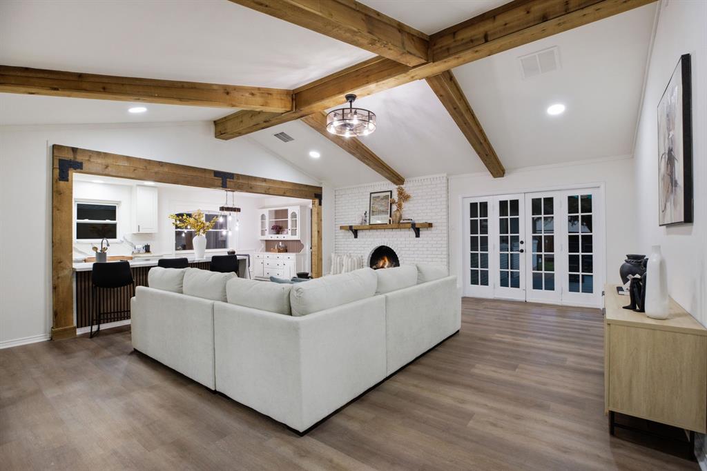 10922 Ferndale Road Dallas, TX 75238 - Photo 2 of 32 Living area featuring a chandelier, a brick fireplace, wood finished floors, recessed lighting, and french doors