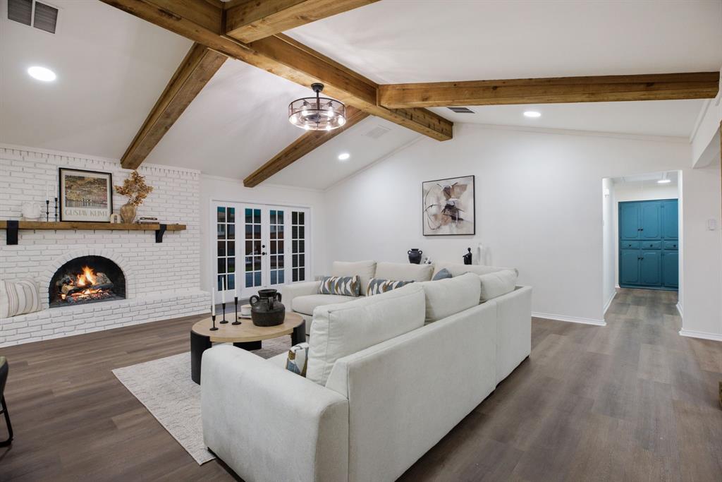 10922 Ferndale Road Dallas, TX 75238 - Photo 25 of 32 Living area with a fireplace, dark wood-style flooring, recessed lighting, and a chandelier