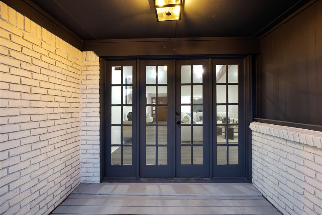 10922 Ferndale Road Dallas, TX 75238 - Photo 27 of 32 View of exterior entry featuring brick siding, french doors, and a deck