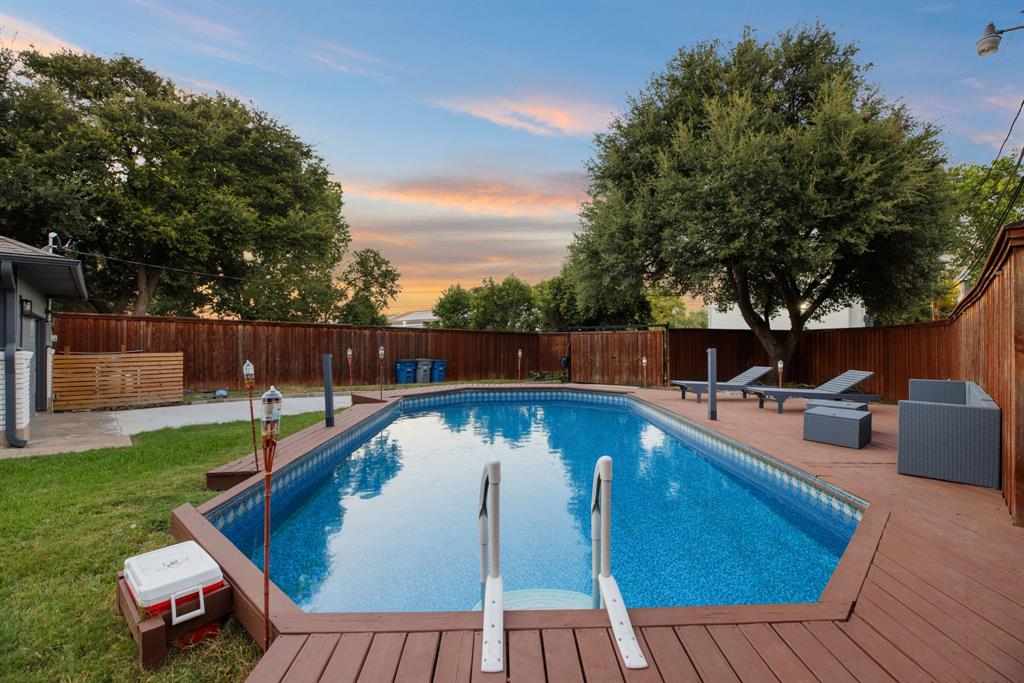 10922 Ferndale Road Dallas, TX 75238 - Photo 29 of 32 Pool at dusk with a patio, a fenced backyard, and a deck