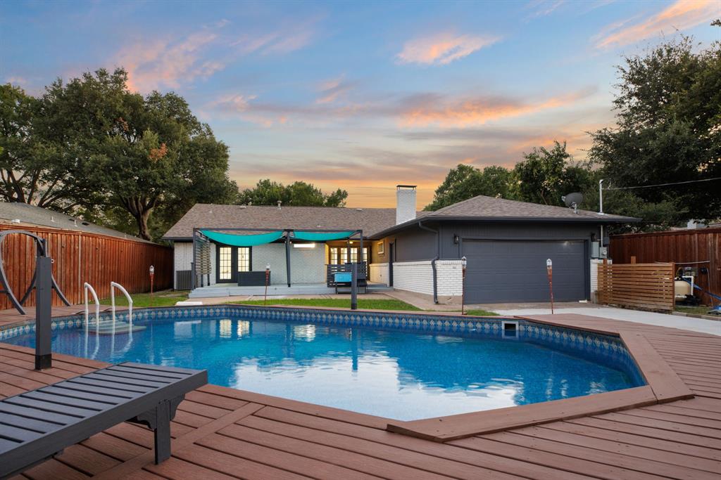 10922 Ferndale Road Dallas, TX 75238 - Photo 32 of 32 Pool at dusk with a patio area and a wooden deck