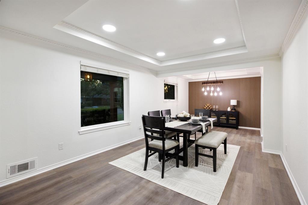 10922 Ferndale Road Dallas, TX 75238 - Photo 7 of 32 Dining room with recessed lighting, a tray ceiling, wood finished floors, and crown molding