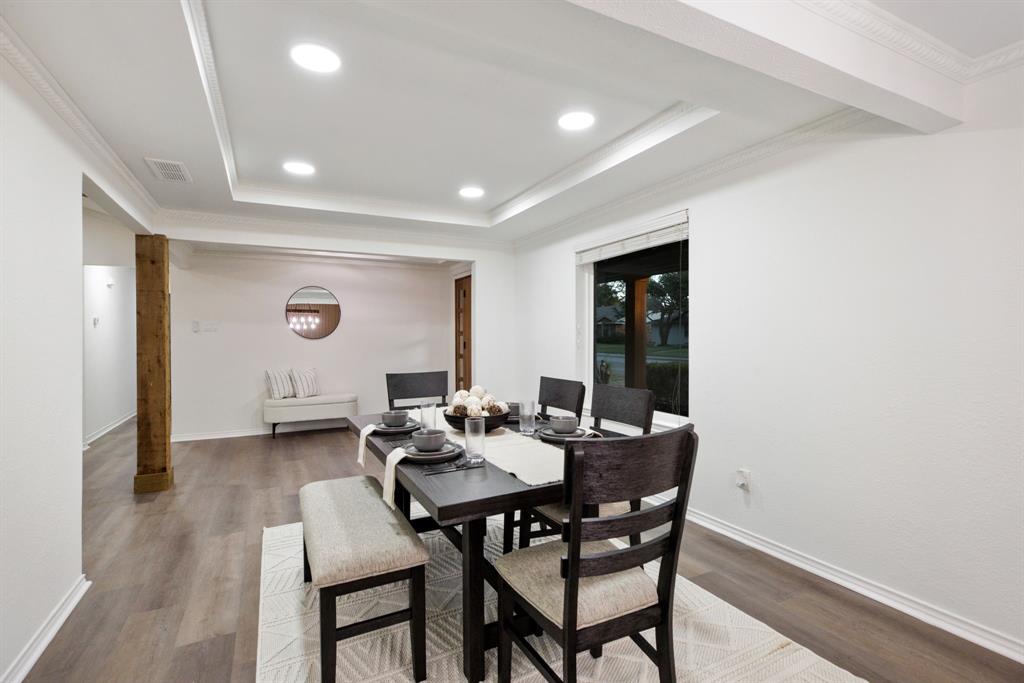 10922 Ferndale Road Dallas, TX 75238 - Photo 9 of 32 Dining room with ornamental molding, recessed lighting, wood finished floors, and a tray ceiling