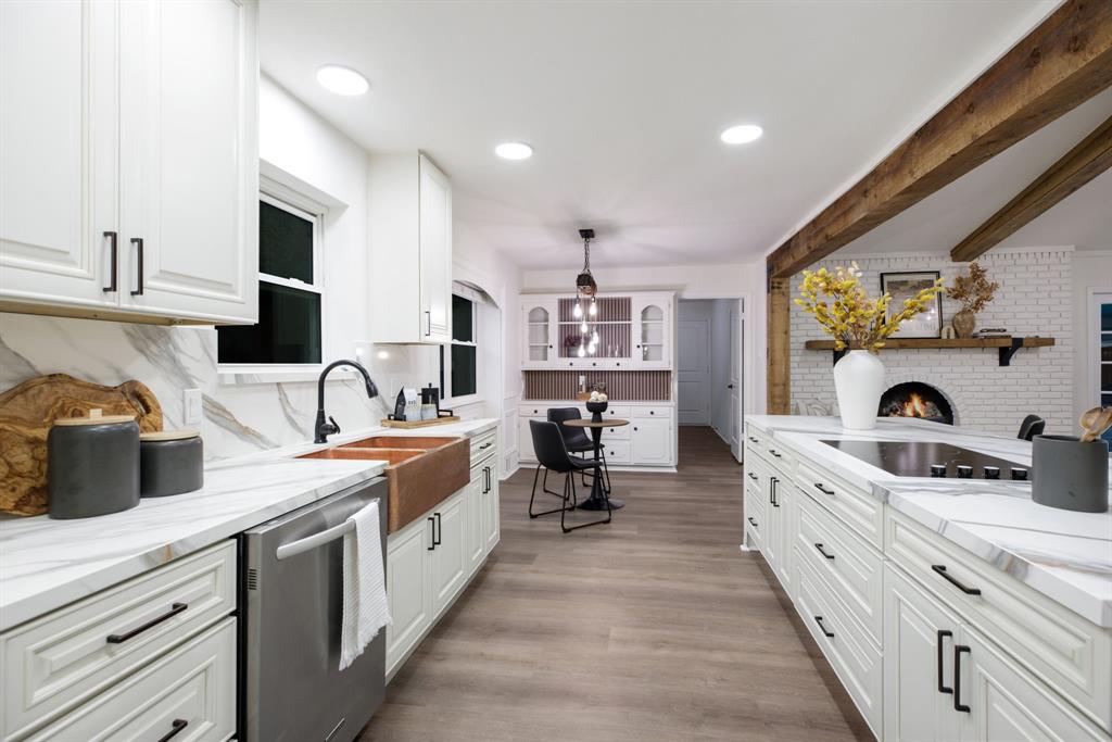 10922 Ferndale Road Dallas, TX 75238 - Photo 10 of 32 Kitchen featuring beamed ceiling, white cabinetry, dishwasher, light wood finished floors, and decorative light fixtures