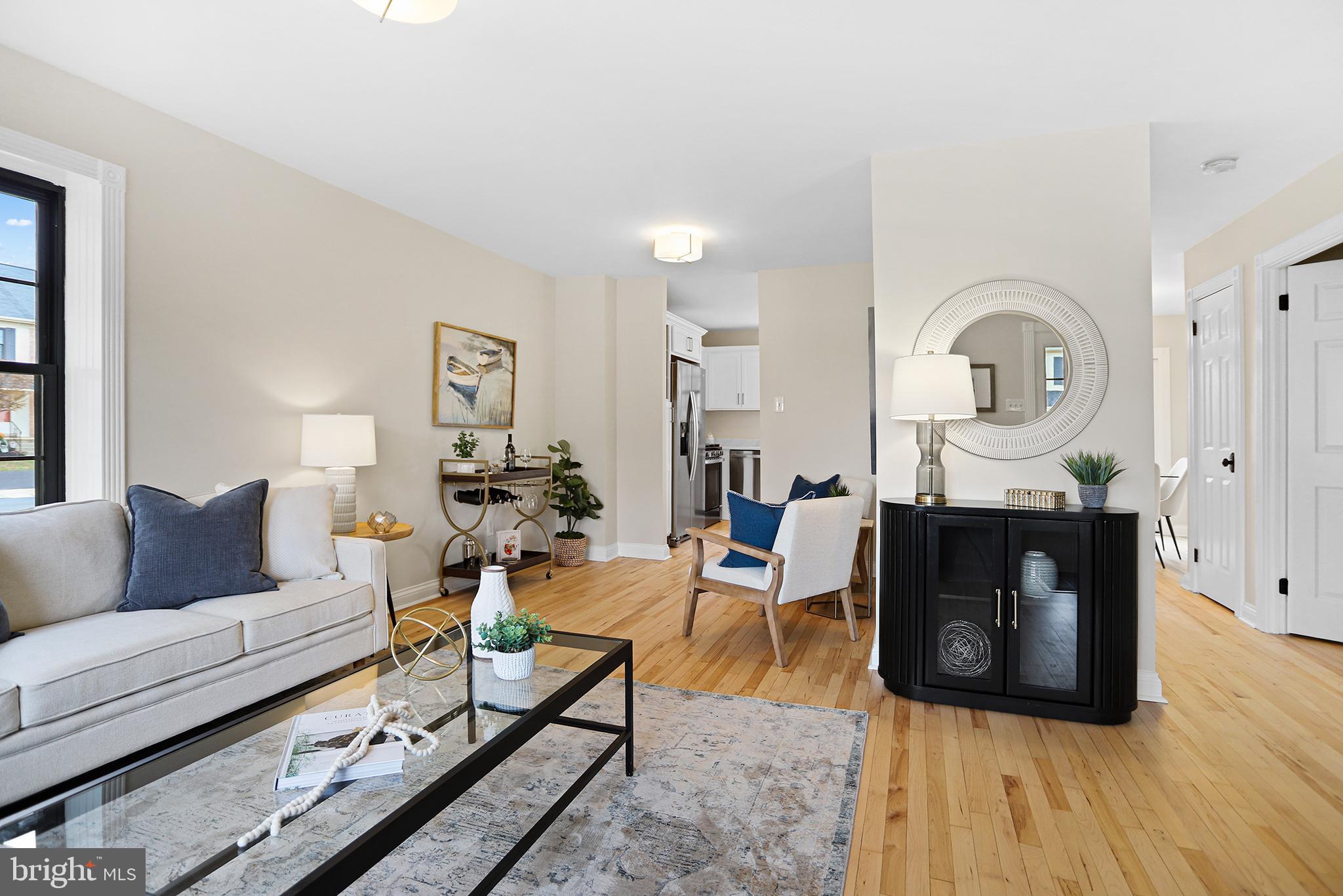 524 Ward Road Brookhaven, PA 19015 - Photo 3 of 22 a living room with furniture a wooden floor and a chandelier