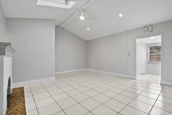 a view of an empty room and wooden floor