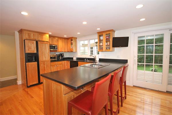195 Conant Road Weston, MA 02493 - Photo 4 of 12 a kitchen with stainless steel appliances granite countertop a sink a stove and a refrigerator