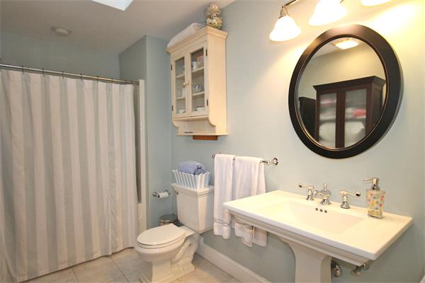 195 Conant Road Weston, MA 02493 - Photo 10 of 12 a bathroom with a sink a mirror a toilet and a sink