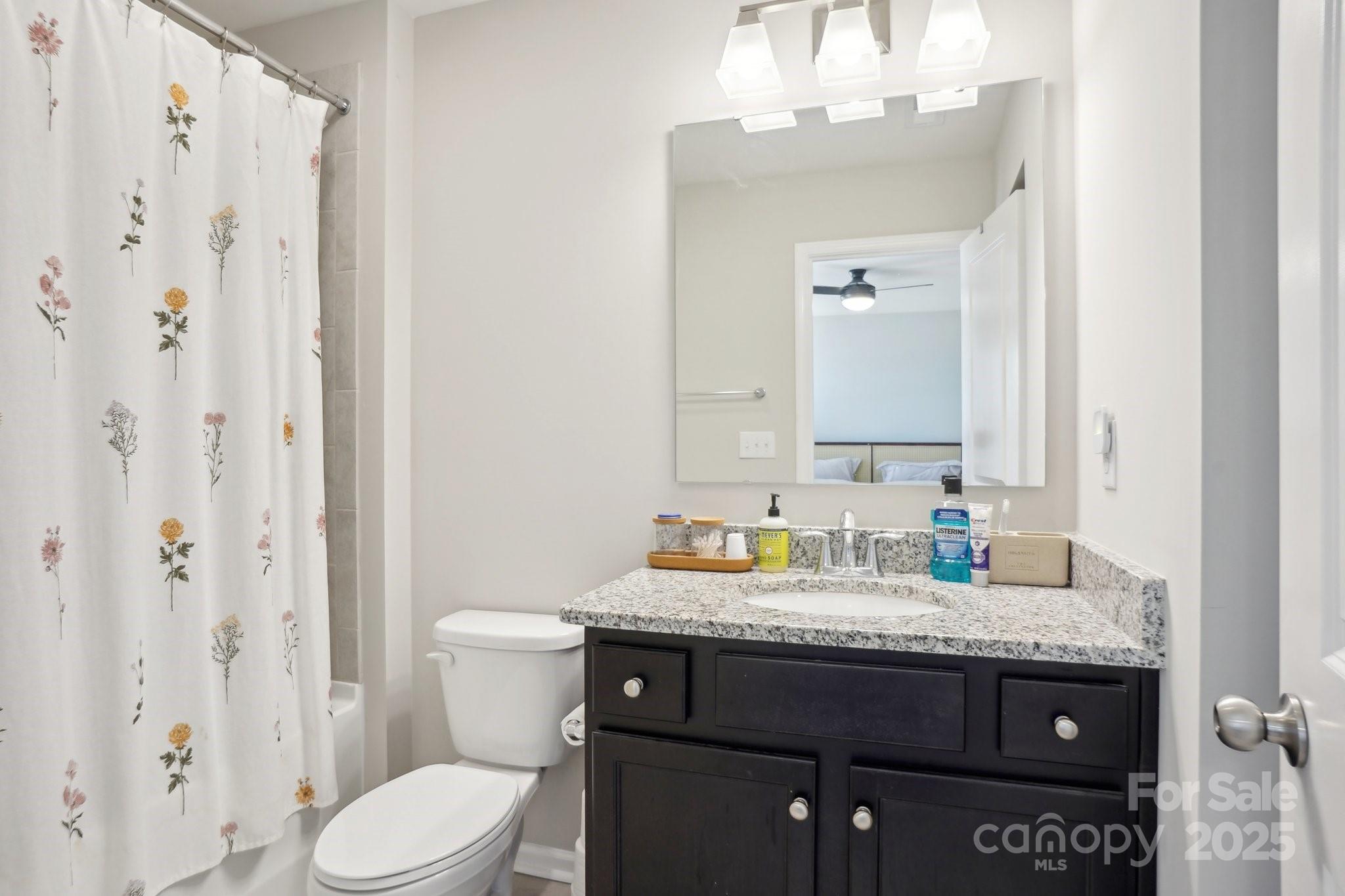 12461 Bryton Ridge Parkway Huntersville, NC 28078 - Photo 18 of 33 a bathroom with a granite countertop sink toilet and shower