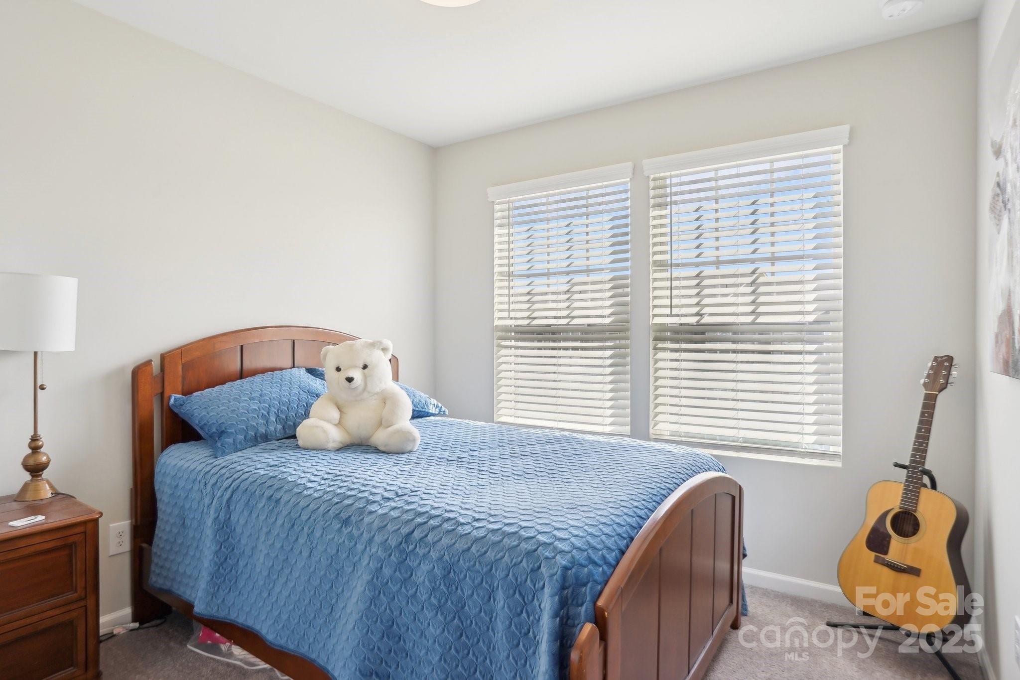 12461 Bryton Ridge Parkway Huntersville, NC 28078 - Photo 21 of 33 a bedroom with a bed and wooden floor