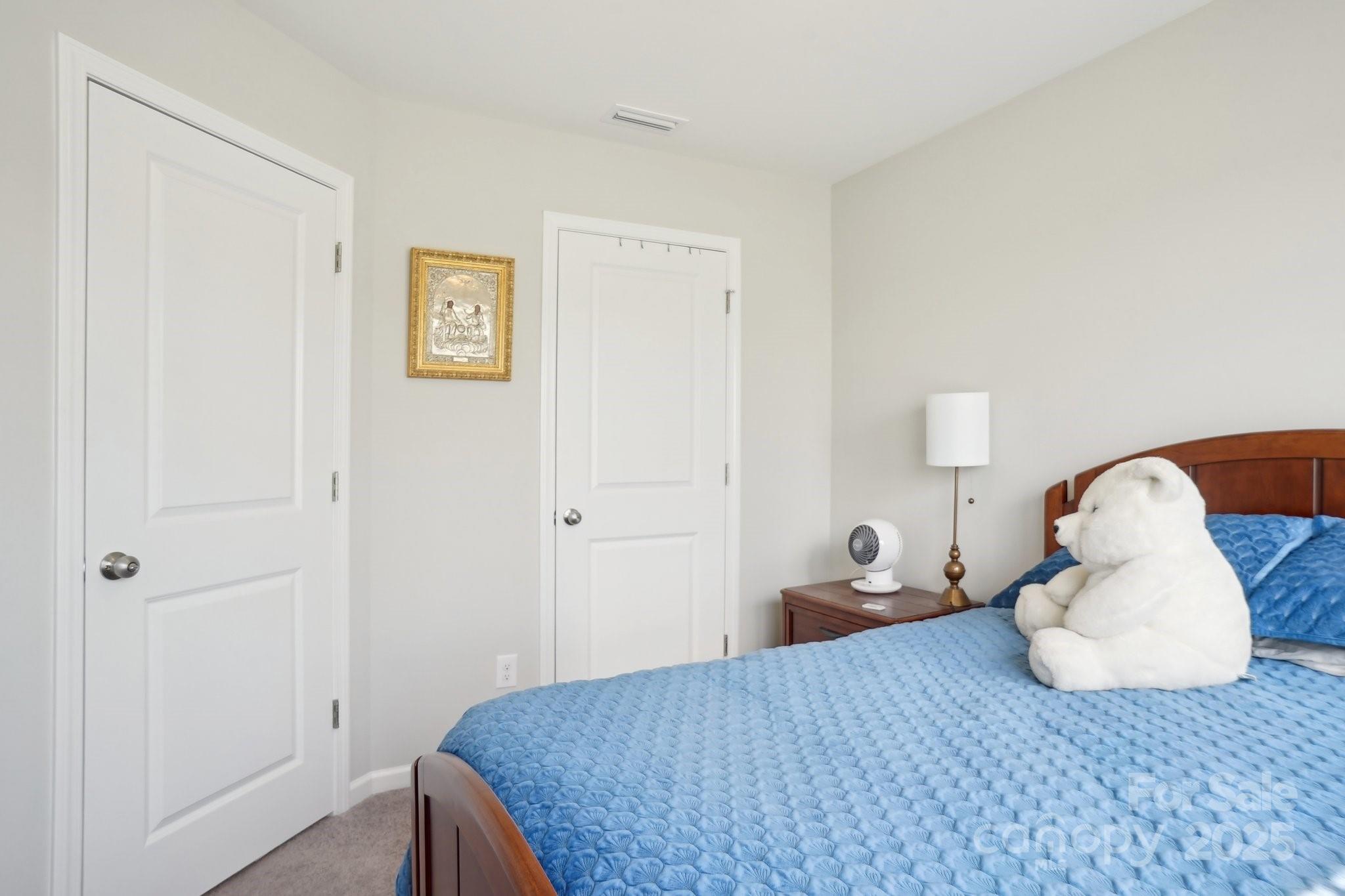 12461 Bryton Ridge Parkway Huntersville, NC 28078 - Photo 23 of 33 a bedroom with a bed and lamp