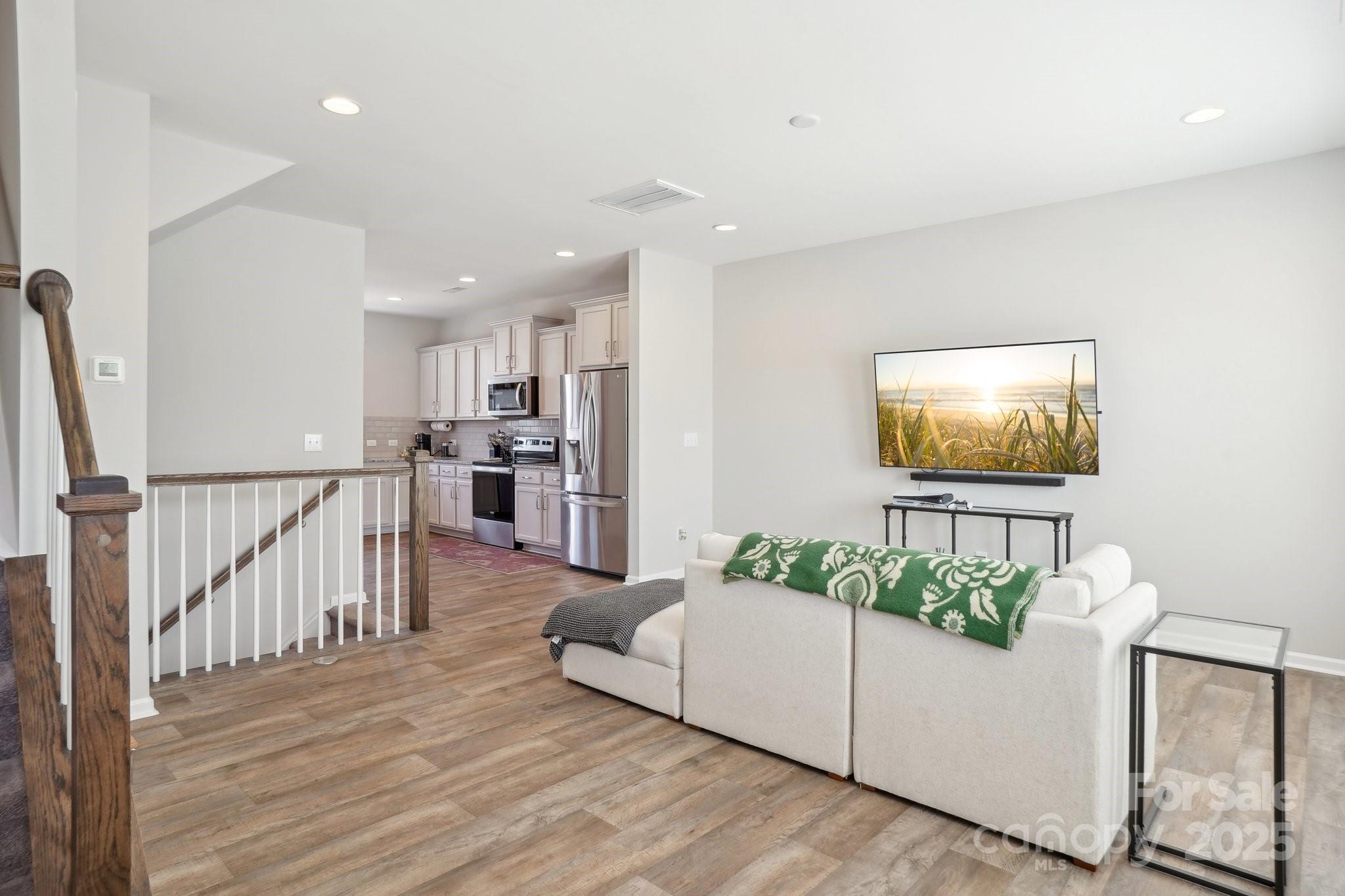 12461 Bryton Ridge Parkway Huntersville, NC 28078 - Photo 4 of 33 a living room with furniture and a flat screen tv