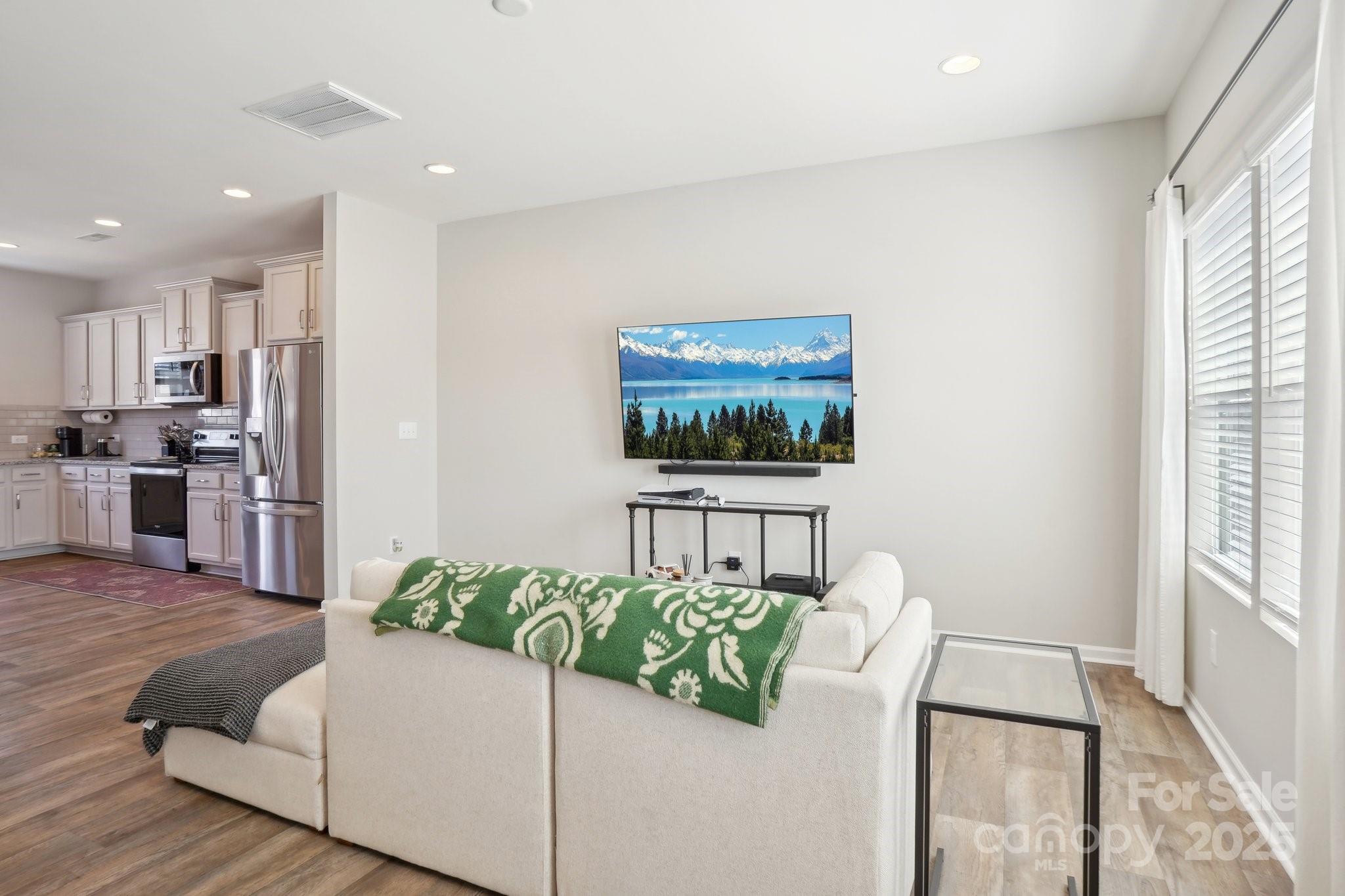12461 Bryton Ridge Parkway Huntersville, NC 28078 - Photo 5 of 33 a living room with furniture and a flat screen tv