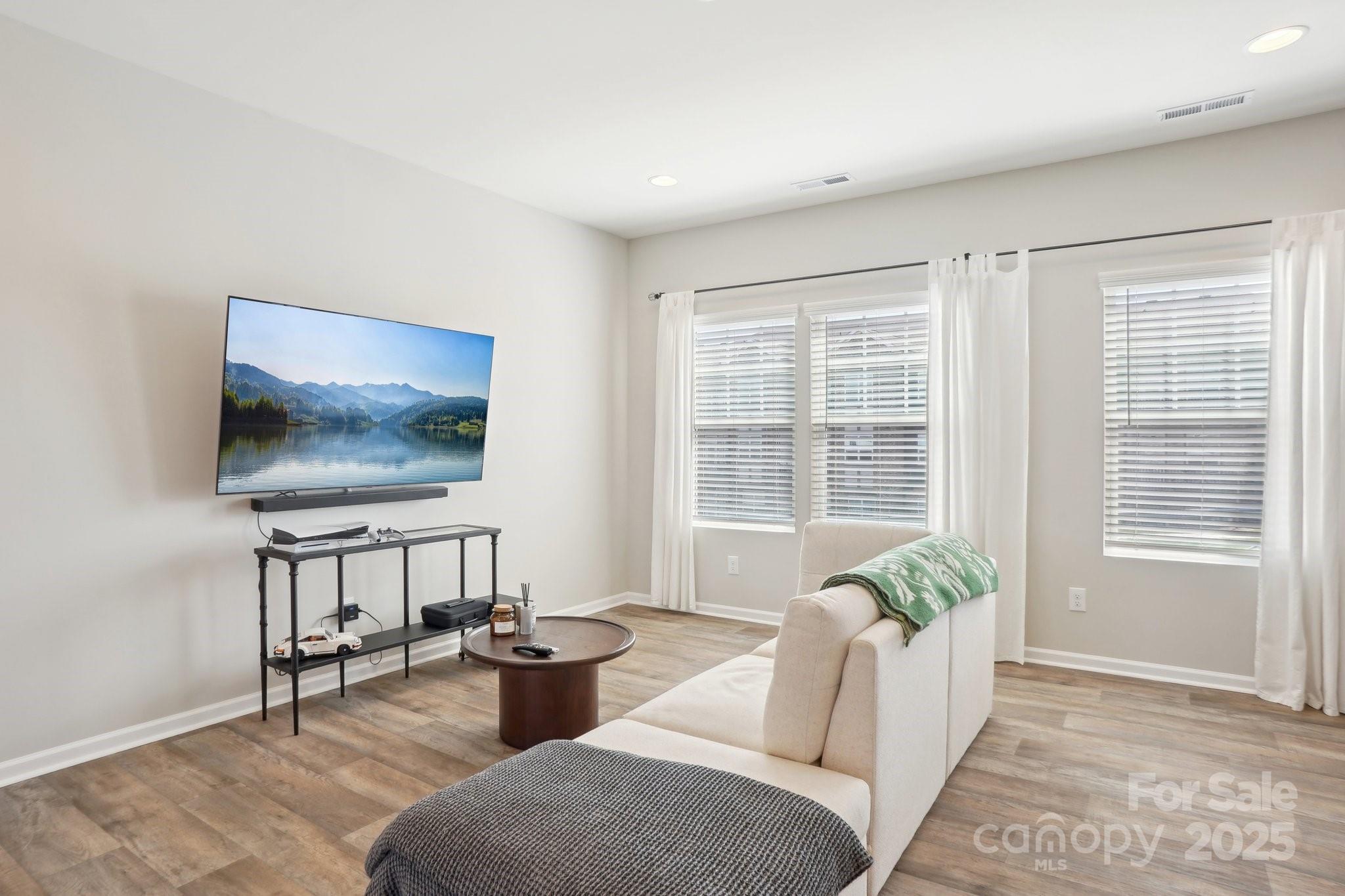 12461 Bryton Ridge Parkway Huntersville, NC 28078 - Photo 6 of 33 a living room with furniture and a flat screen tv