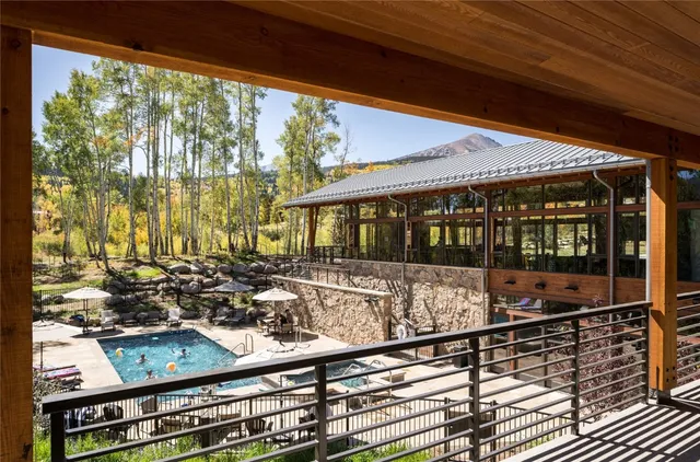 a view of a porch with wooden floor and outdoor seating