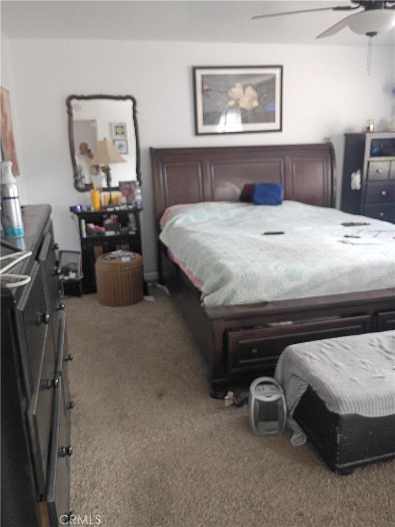 201 South Greenlawn Street Ridgecrest, CA 93555 - Photo 13 of 31 a bedroom with a bed and a chandelier