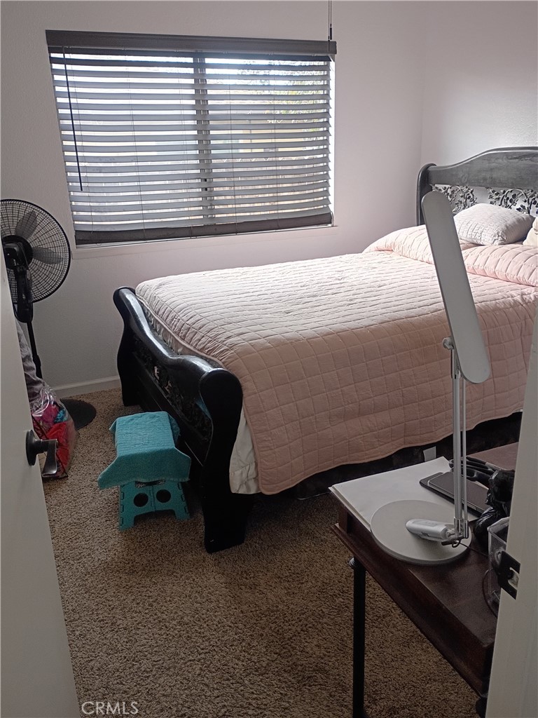 201 South Greenlawn Street Ridgecrest, CA 93555 - Photo 22 of 31 a bedroom with a bed and a table
