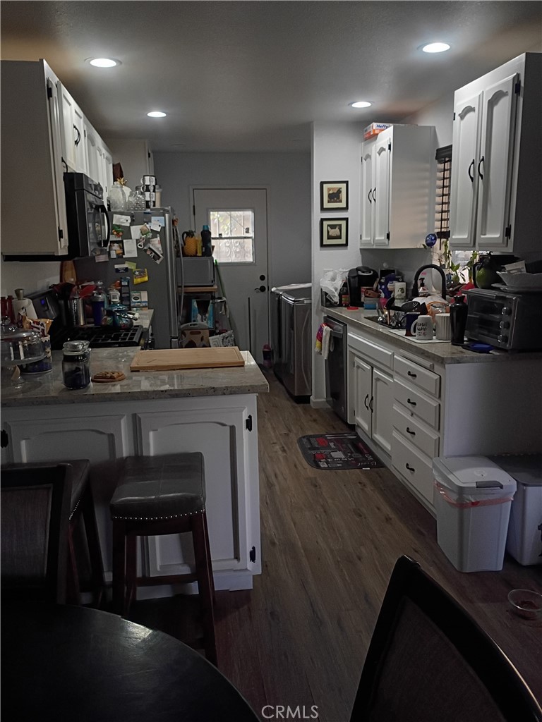 201 South Greenlawn Street Ridgecrest, CA 93555 - Photo 31 of 31 a kitchen with stainless steel appliances granite countertop a stove refrigerator and cabinets