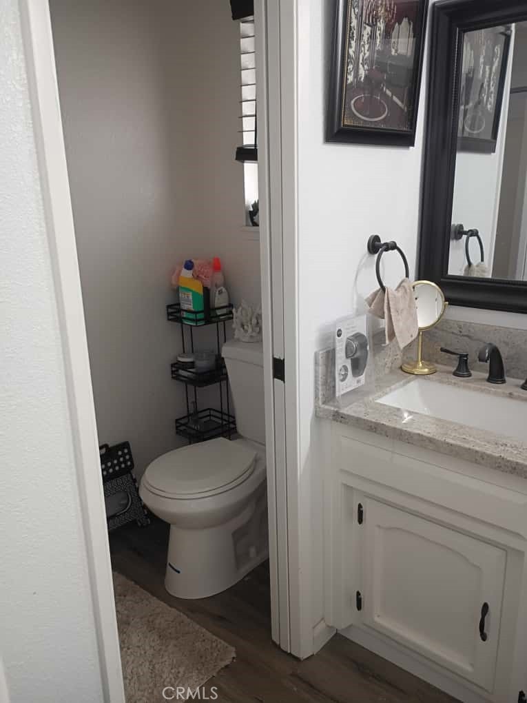 201 South Greenlawn Street Ridgecrest, CA 93555 - Photo 6 of 31 a bathroom with a toilet sink and mirror