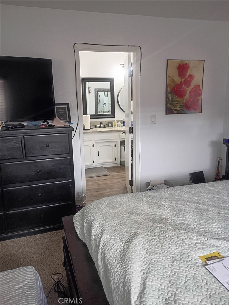 201 South Greenlawn Street Ridgecrest, CA 93555 - Photo 8 of 31 a bedroom with a bed and a flat screen tv