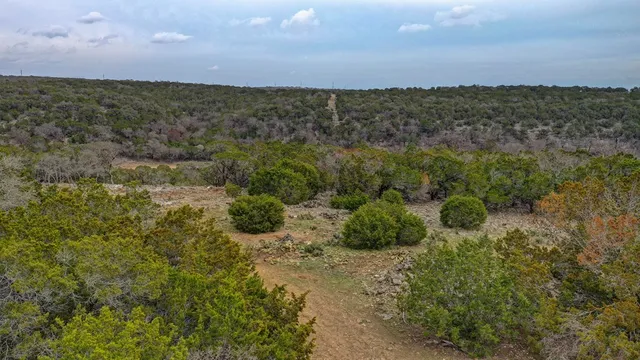 an aerial view of a houses with a yard