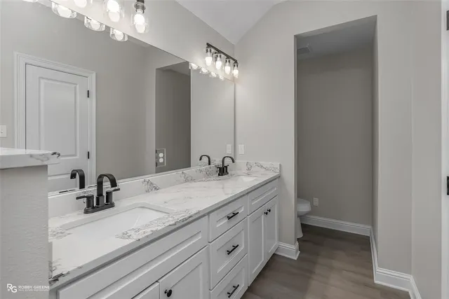 a bathroom with a double vanity sink and a mirror