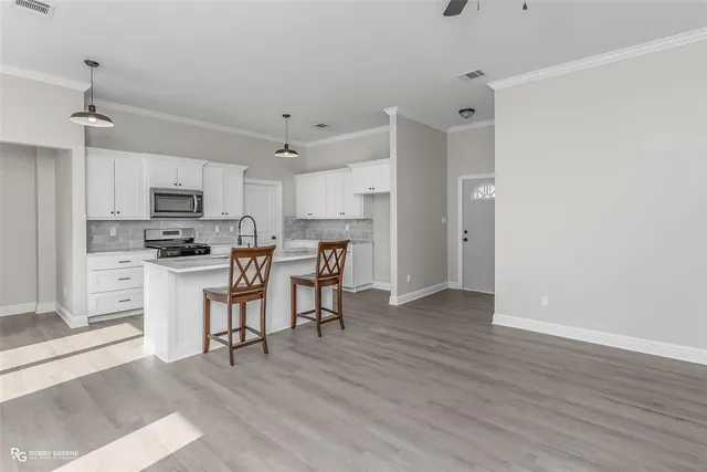 a kitchen with stainless steel appliances a refrigerator sink and microwave