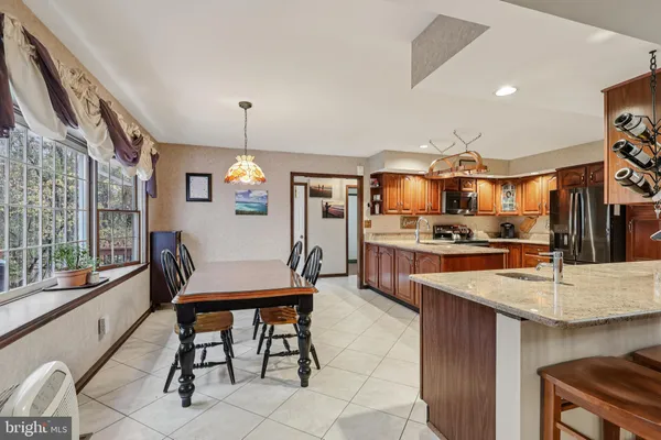 a kitchen with counter top space cabinets stainless steel appliances and a chandelier