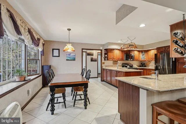 a kitchen with counter top space cabinets stainless steel appliances and a chandelier