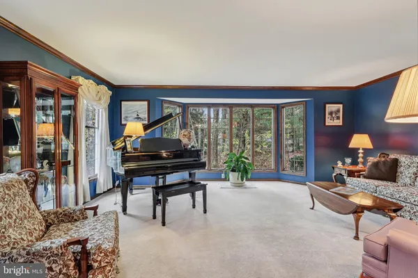 a living room with furniture a ceiling fan and a window