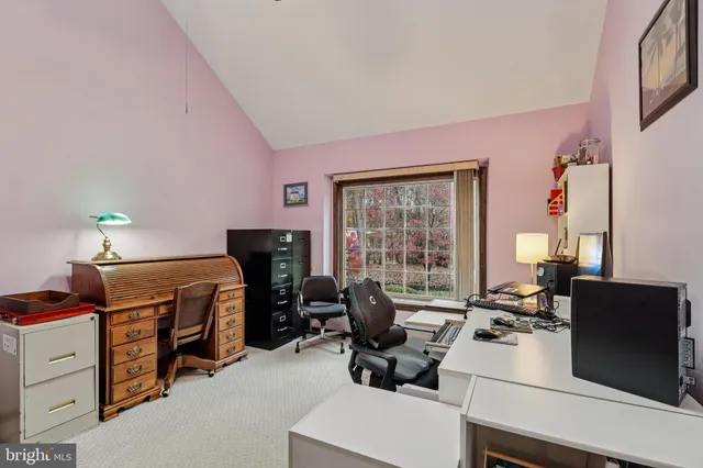a bedroom with a large bed and a flat tv screen