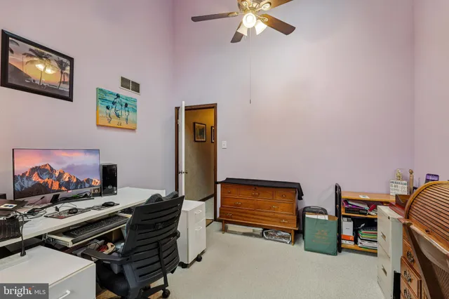 a bedroom with a bed a dresser and flat screen tv