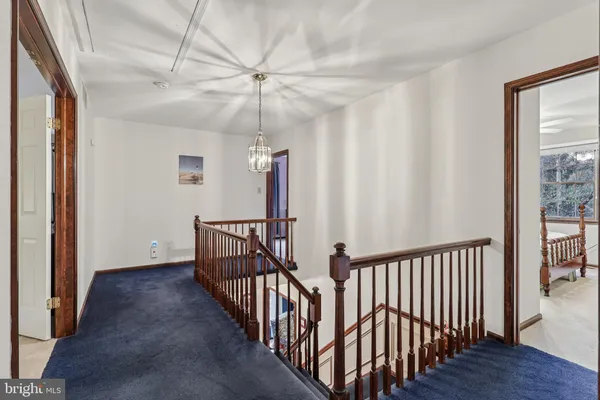 a bedroom with a bed a mirror and a window