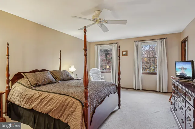 a bedroom with a bed a mirror and a window