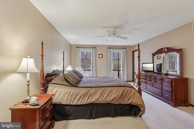 a bedroom with a bed and a flat tv screen