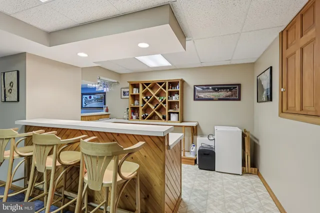 a view of a patio with table and chairs with wooden floor and fence