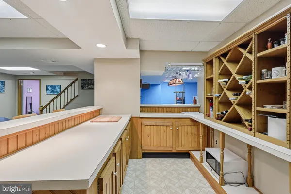 a front view of a house with a garden and trees