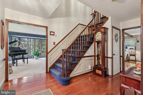 a living room with fireplace furniture and a wooden floor