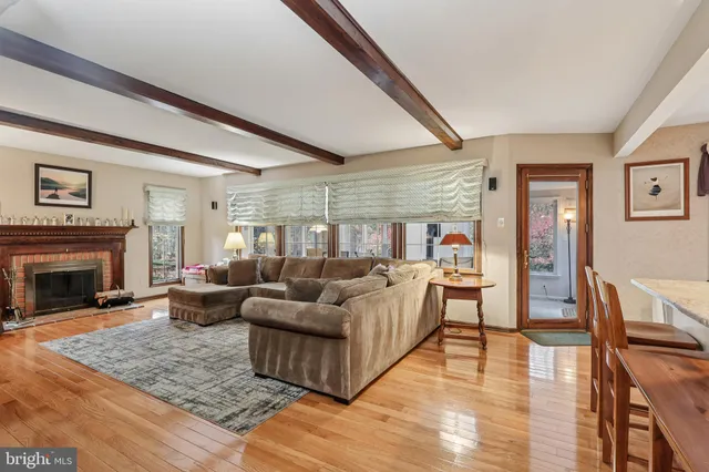 a living room with furniture a fireplace and a book shelf