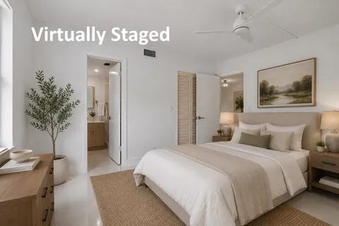 a bedroom with a bed and a potted plant