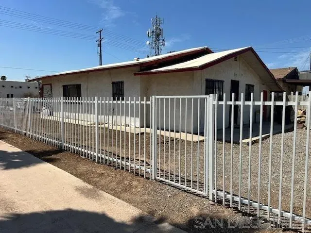 a front view of a house with wooden fence