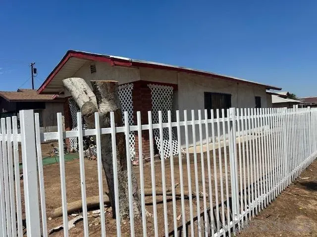 a view of a house with a wooden fence
