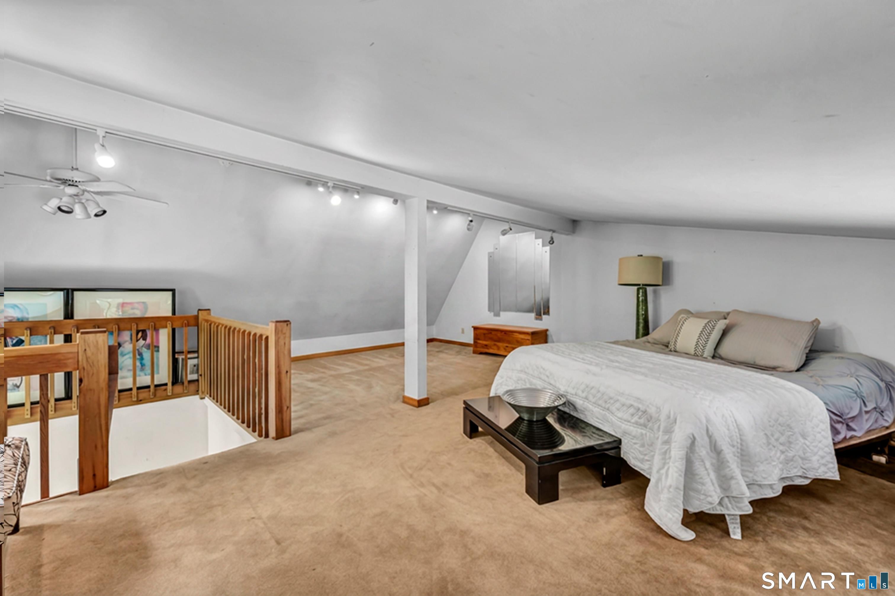 106 Hunt Road Columbia, CT 06237 - Photo 38 of 40 a bedroom with a bed a mirror and gym equipment